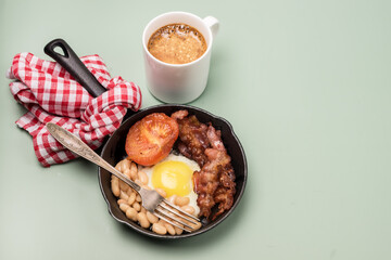 English Breakfast Fried Egg Beans Tomatoes Bacon English Breakfast Served in Frying Pan Light Green Background Copy Space