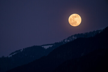 at sunrise on the mountains and the moon goes down