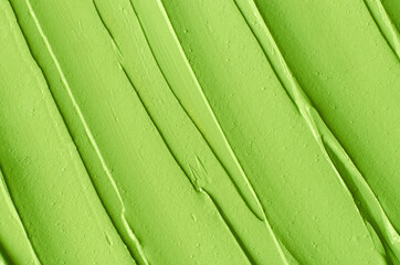 Green cosmetic clay (cucumber facial mask, avocado face cream, green tea matcha body wrap) texture...