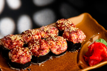 Sushi and rolls, Japanese sea cuisine. Served plates for the restaurant menu on a black background.