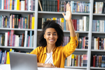 Excellent female student. Smart african american student girl at a lecture sits at a table,...