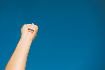 Fists raised in the colors of the rainbow symbol of diversity, lgtb concept