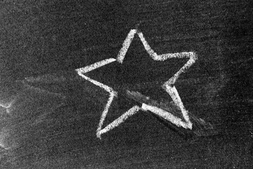 White color chalk hand drawing as star shape on blackboard  or chalkboard background