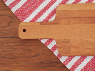 Fototapeta premium Cutting board or chopping board on wooden table. Wooden plate on desk. Top view