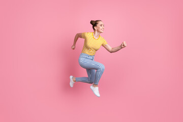 Fototapeta na wymiar Full size profile photo of attractive cheerful girl running look empty space isolated on pink color background