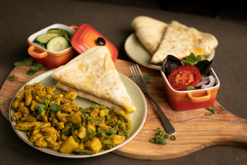 Indian-surinamese spicy food lunch and dinner, roti chicken curry