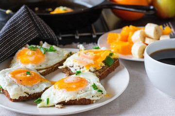 Savory breakfast with fried egg sandwich coffee and fruits