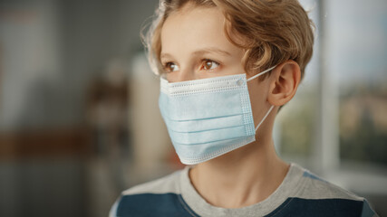 Portrait of a Handsome Stylish Young Boy Wearing Protective Face Mask Indoors. Brown Eyed Blonde Haired Male Respects Quarantine Rules, Lockdown Measures and Safe Social Distancing. Pandemic Concept.