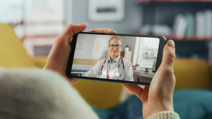 Close Up of a Female Chatting in a Video Call with Her Female Family Doctor on Smartphone from...