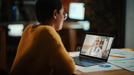 Beautiful Multiethnic Latina Manager is Making Video Call to His Doctor on Laptop in a Creative Office Environment. Man is Talking to His Medical Consultant Over a Live Camera, Asking about Health.