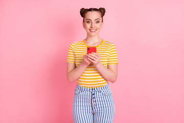 Photo of charming positive person hands hold phone toothy smile look camera isolated on pink color background