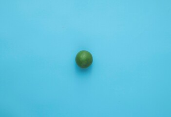 Natural fresh lime isolated on blue background