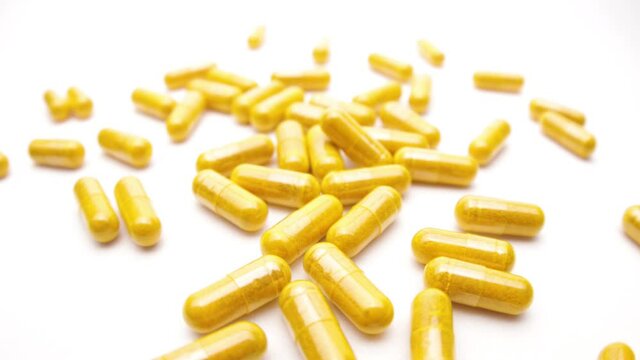 colorful nutritional diet supplement vitamin pills capsules on a white background