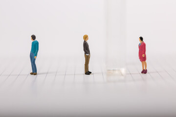 Fototapeta premium Social distancing, people keeping distance to protect COVID-19 coronavirus outbreak spreading concept, miniature keep distance each other using plexiglass.