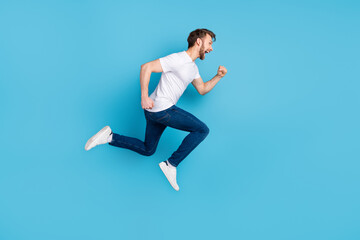 Fototapeta na wymiar Full length profile photo of sportive handsome guy open mouth look empty space isolated on blue color background