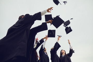 New stage of life. Graduates toss their academic hats into the sky during a solemn ceremony at the...