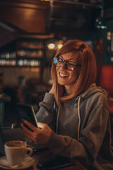 Woman using a smartphone in a cafe