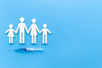 Vaccination concept with family shape. Vaccine vial dose in syringe