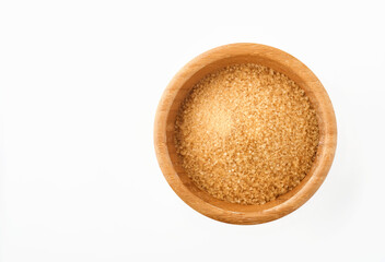 Cane sugar in bamboo bowl isolated on white background. Top view.