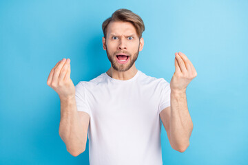 Photo of displeased crazy person hands fingers show money symbol open mouth isolated on blue color background