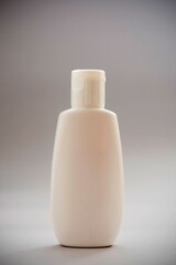 White blank plastic bottle on gray background. Group of skin care blank products, abstract beauty concept