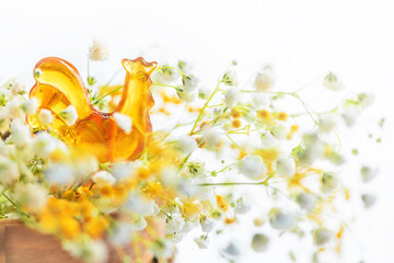 lollipop honey cockerel on a stick among spring flowers