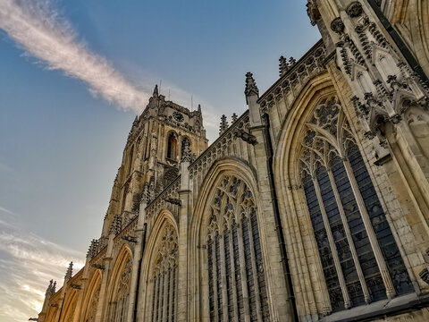 Gothic church Basilica of our Lady at the main square in Tongeren, Belgium, at sunset with a clear blue sky.