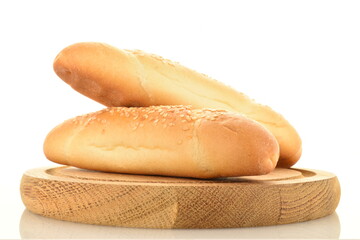 Two delicious fragrant bagels on a round wooden tray, close-up, isolated on white.