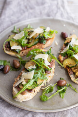 Vegetarian bruschette with olives and courgettes