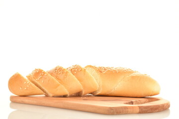 One fragrant bagel cut into slices sprinkled with sesame seeds on a wooden board, close-up, isolated on white.
