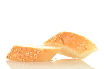 Two slices of fragrant bagel sprinkled with sesame seeds, close-up, isolated on white.