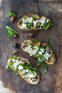 Vegetarian bruschette with olives and courgettes