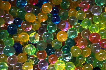 Colored transparent beads of hydrogel as background.