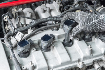 Auto mechanic Installing modify ignition coil on car engine, Car Modify, Car maintenance service. - obrazy, fototapety, plakaty