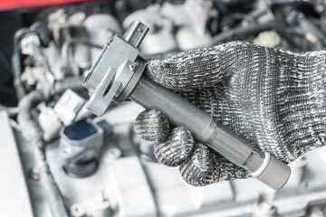 Auto mechanic hand with ignition coil, Car Modify, Car maintenance service.