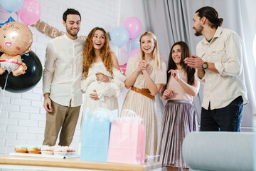 Couple talking and laughing with her friend during gender reveal party