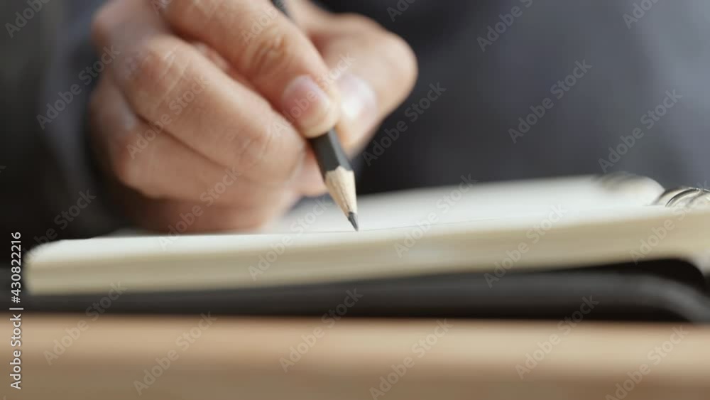 Poster close-up of writing on notebook with pencil