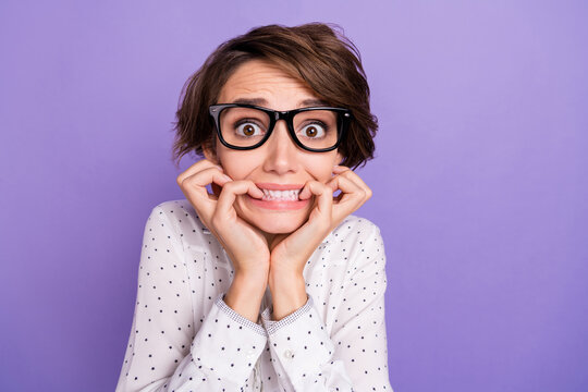 Photo Of Nice Brunette Short Hair Scared Lady Bite Fingers Wear Shirt Isolated On Lilac Color Background