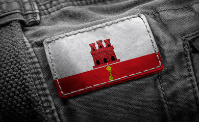 Tag on dark clothing in the form of the flag of the Gibraltar