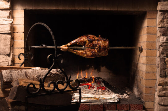 the back of a lamb on a spit with a glass of brandy