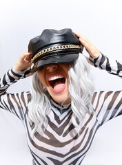 Emotional androgenic blonde model in freak stylish zebra print clothes and leather trendy black cap...