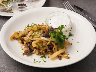fried potatoes with onions and mushrooms with sour cream
