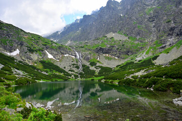 Naklejka na ściany i meble Landscape of the High Tatra mountains. Lake Velicke pleso, waterfall Velicky vodopad and mountains. Slovakia.
