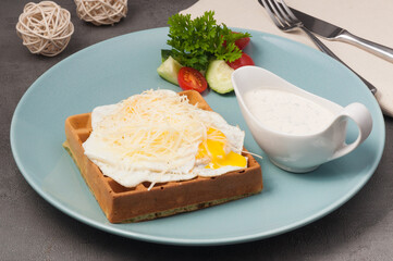 spinach waffle with poached egg, cheese and sauce