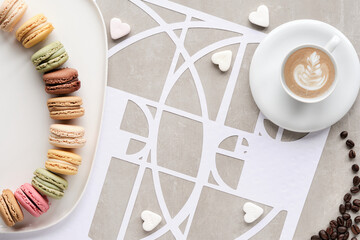 Coffee cup, macarons, Fibonacci sequence circles, sugar hearts. Tasty perfection. Floral latte art, coffee beans. Golden ratio concept. Top view, geometric paper art. White, beige pastel colors.
