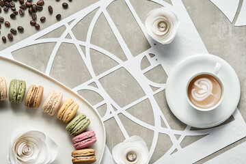 Coffee cup, macarons, Fibonacci sequence circles, sugar hearts. Tasty perfection. Floral latte art, coffee beans. Golden ratio concept. Top view, geometric paper art. White, beige pastel colors.