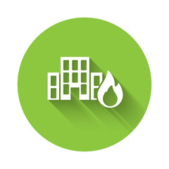 White Fire in burning buildings on city street icon isolated with long shadow. Destroyed city on fire. Green circle button. Vector