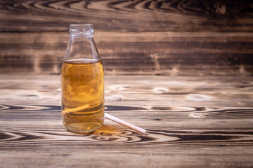 kombucha cocktail bottle on wooden background