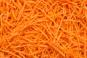 Grated carrots. Full frame of fresh organic shredded carrots
