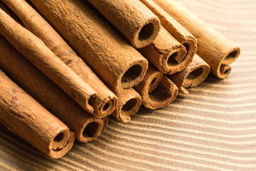 Group of dry cinnamon sticks on acacia tree plate